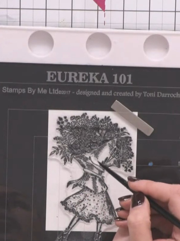 Step 2: Load a clean brush with water and paint over the entire skirt area of the stamped lady image to prepare the su