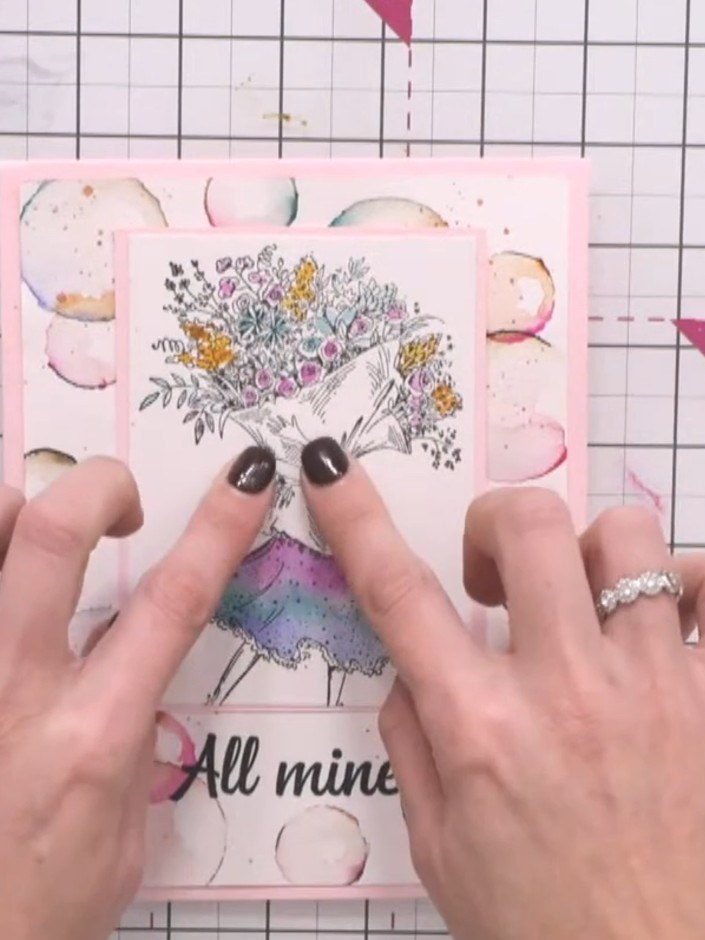 Stap 6: Position your completed layered design onto the final card base. Ensure all elements are properly aligned and 