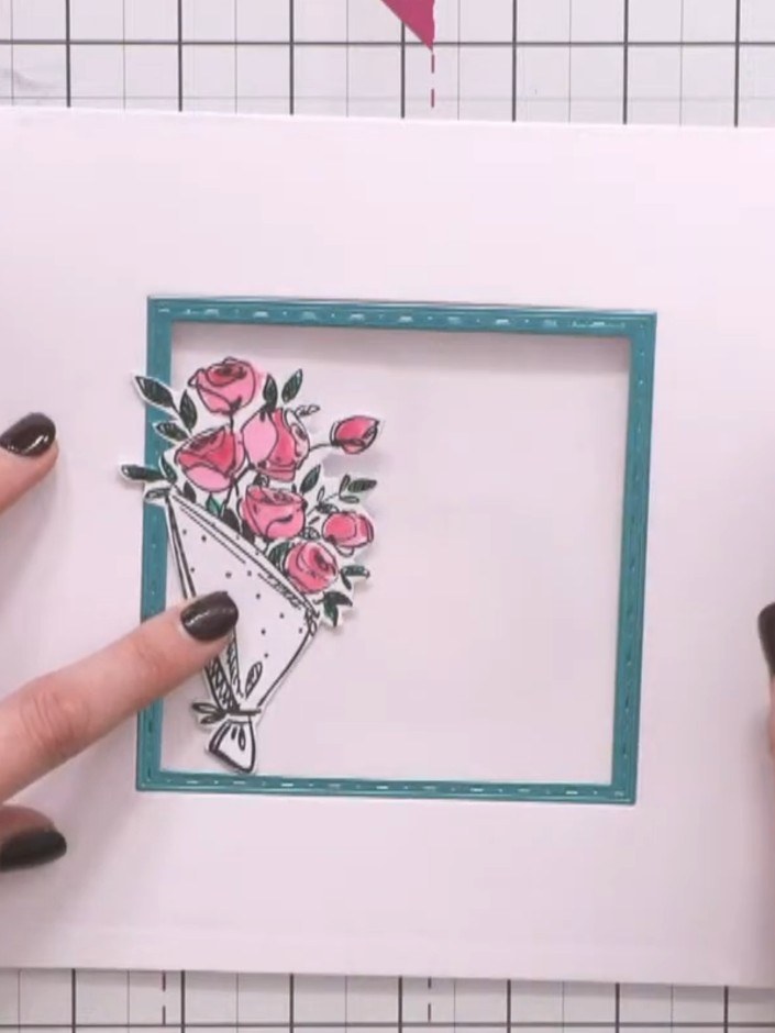 Passo 12: Apply glue to the back of the coloured bouquet piece and attach it to the front of the card. Position it caref