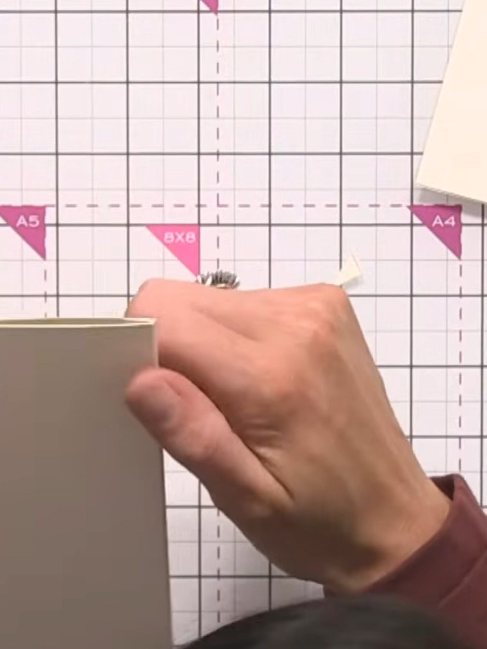 Step 9: Punch a hole through both layers at the top centre of the wallet to create a pocket detail.