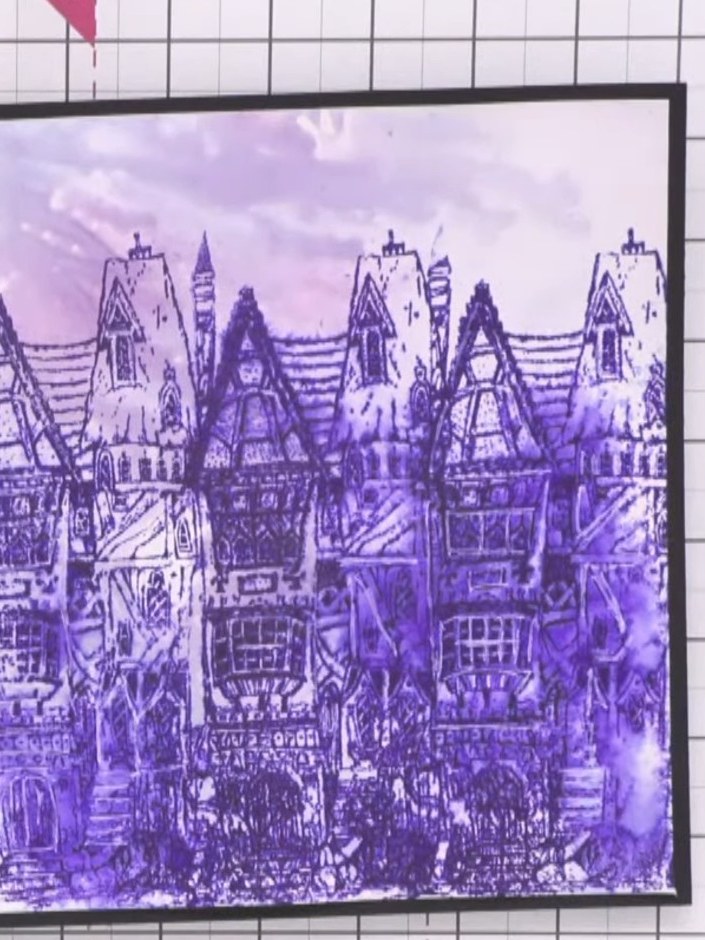 Paso 12: Mount the finished stamped artwork onto your card base using the black frame. The purple stamped houses design