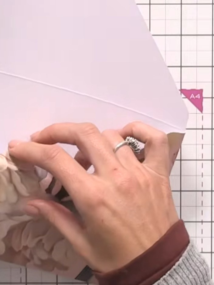 Step 9: Score down the flap of the envelope to complete it. Use the box and envelope maker to create a crisp fold line