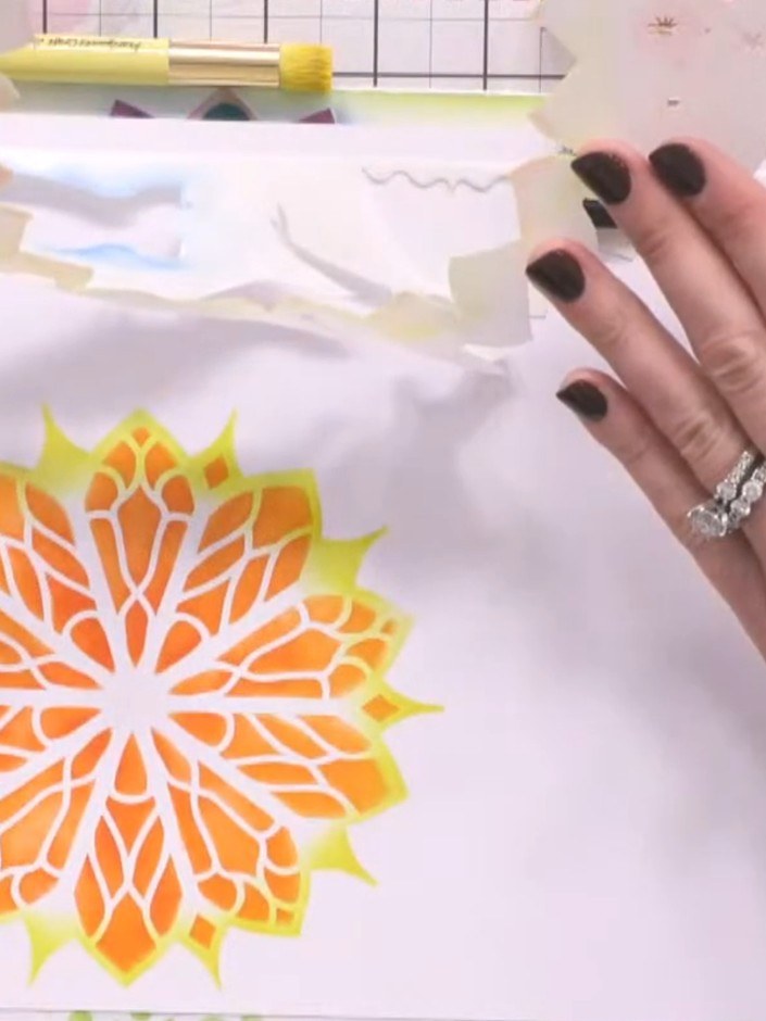Stap 7: Allow the ink to dry completely before carefully removing the stencil from the card. Lift the stencil slowly t