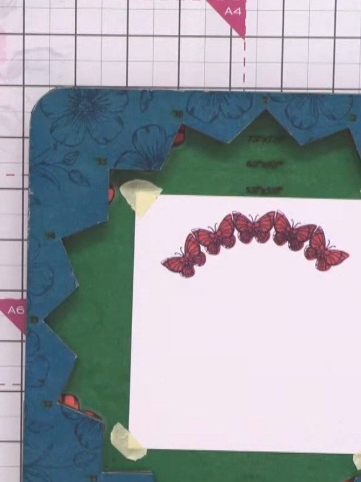 Paso 5: Continue stamping additional butterfly images in different sizes and orientations across your card using the E