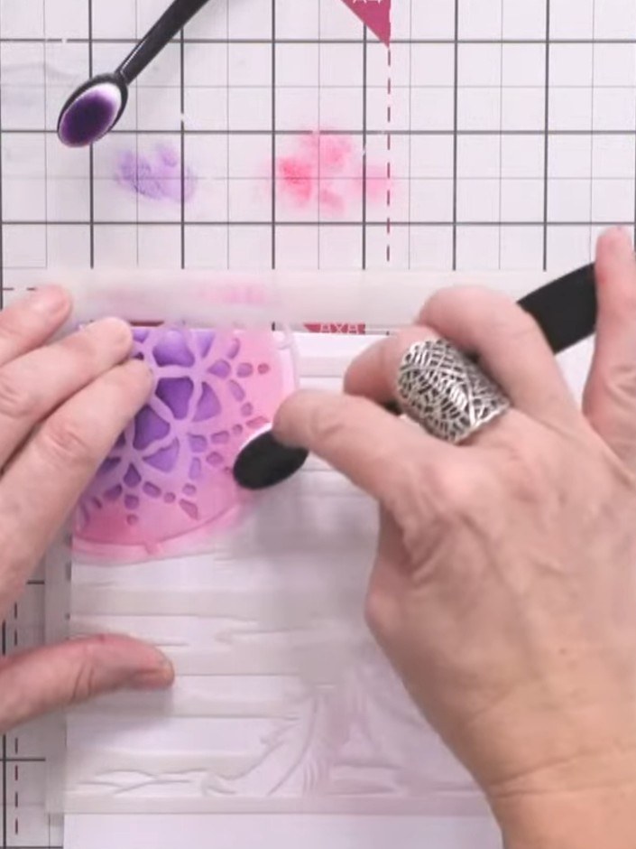 Passo 6: Stamp the A6 dreamcatcher image onto a patterned paper panel using black ink, positioning it slightly off the 