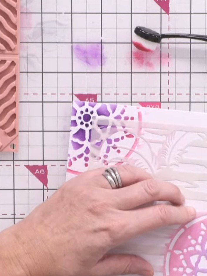 Passo 7: Apply watercolour to the moth stencil element using the same blending technique. Use pink and purple inks to c