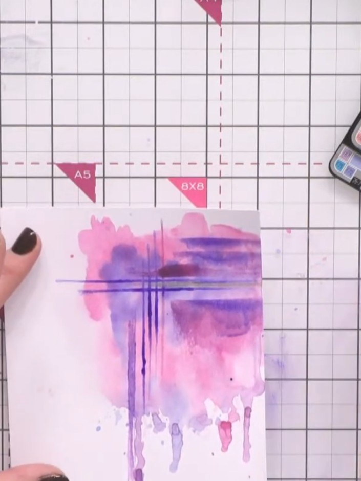 Stap 10: Mix white paint with water and use a brush to add splats and fine lines across the watercolour background. Thi