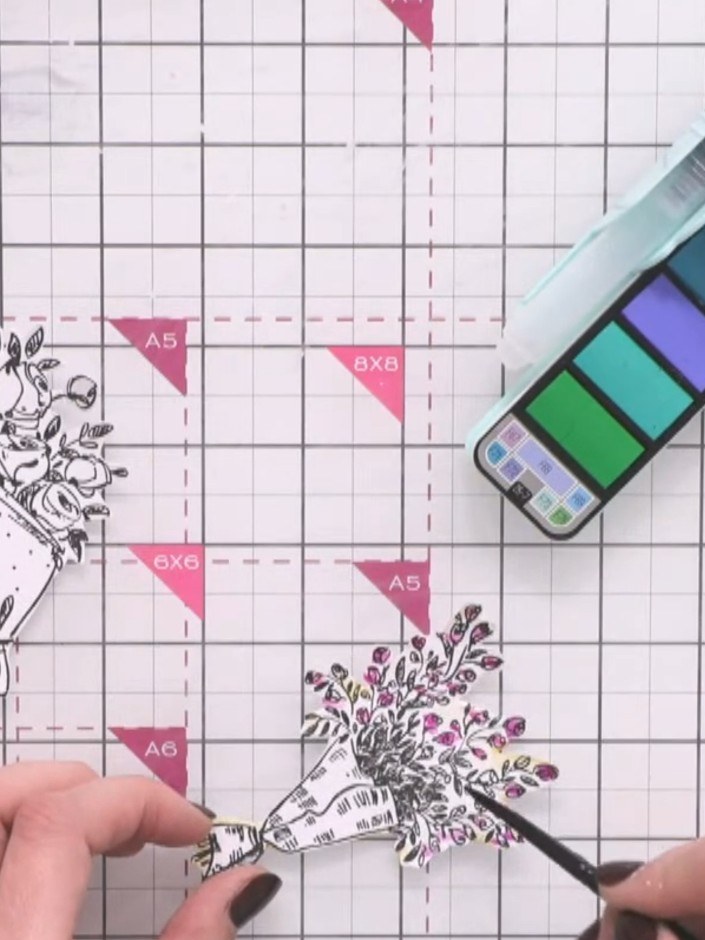 Passo 5: Add green watercolour to the leaves and stems of the stamped flowers by pouncing the colour on with a brush. W