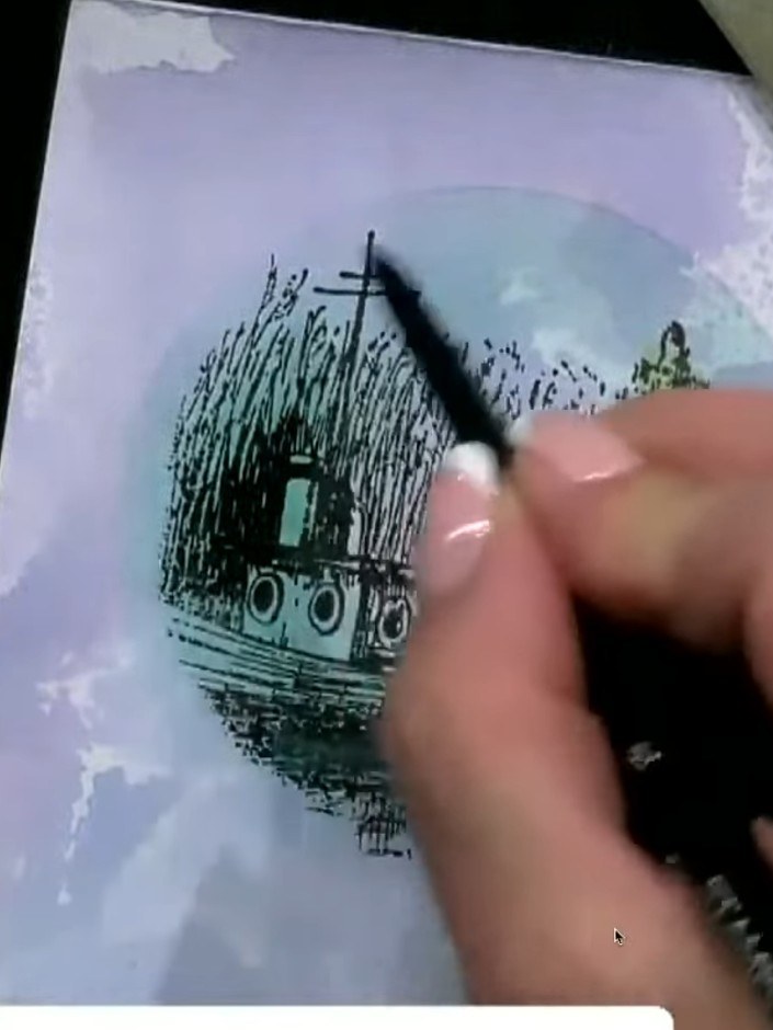 Passo 7: Apply a loose watercolour wash using green tones over the stamped boat and reeds image. Work the colour over t