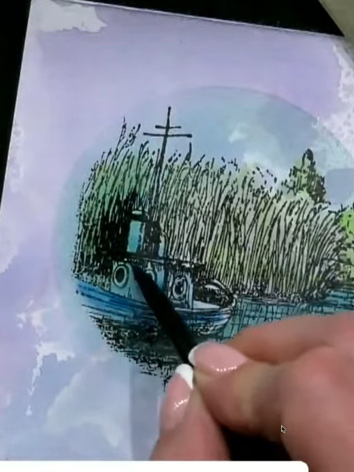 Passo 8: Using a darker blue ink or watercolour, add shading to the edges of the circular stamped image to create depth