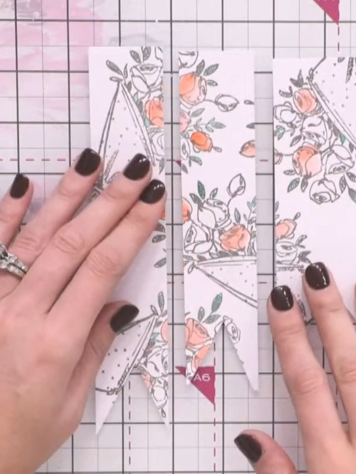 Stap 5: Layer a piece of black cardstock as your base. Adhere your banner pieces on top at different heights using foa