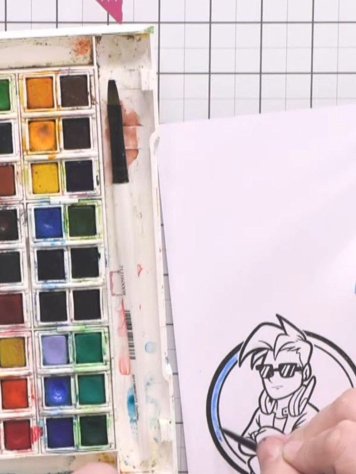 Paso 12: Colour the character using watercolours. Apply blue and green tones around the character, adding darker shades