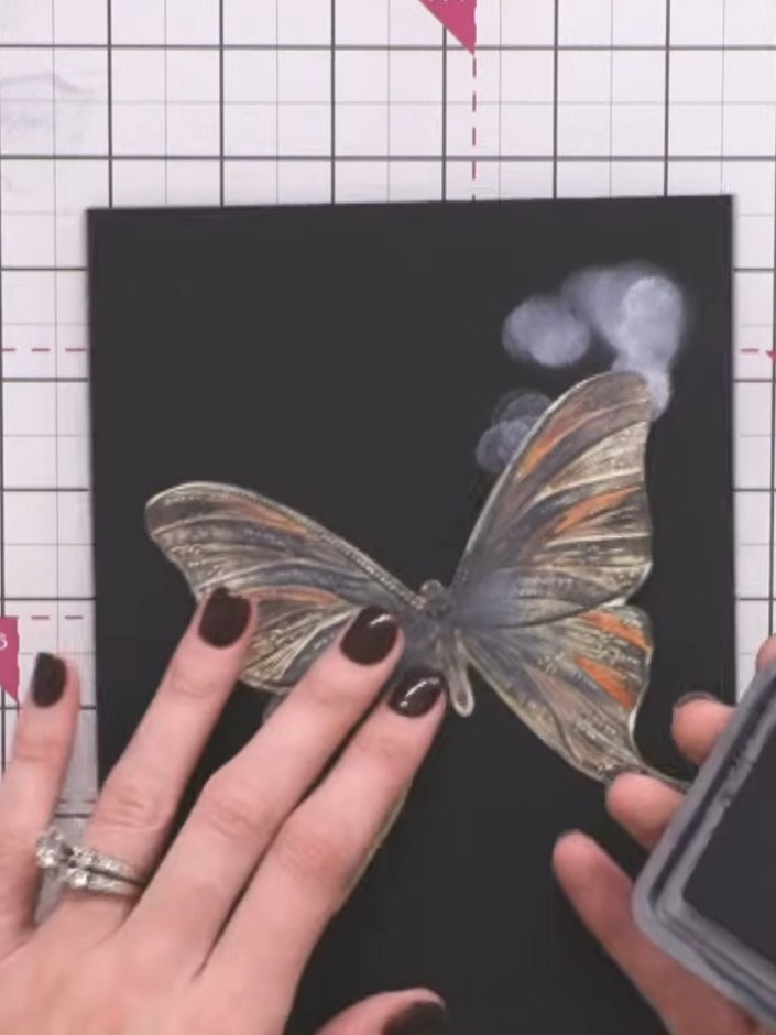 Passo 10: Swipe a black ink pad across the butterfly at an angle to pick up all the embossed lines and add definition to