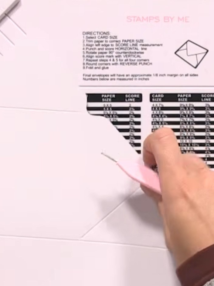 Step 5: Rotate the board once more and complete the final punch and score along the horizontal line using the pink sco
