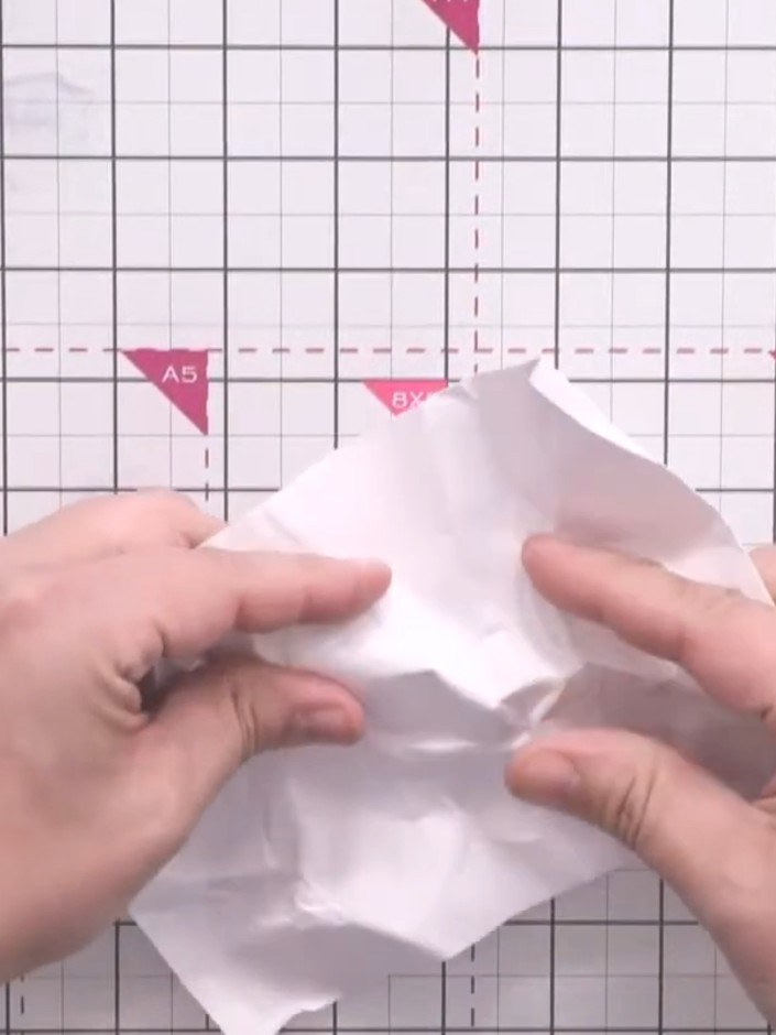 Step 2: Scrunch the white card up tightly in your hands to create deep creases throughout the paper. Work the card int