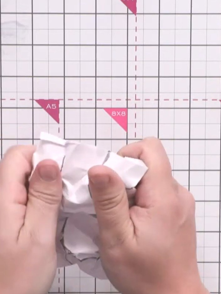 Step 7: Scrunch the card up again in different places to create additional crease marks and texture throughout the pap