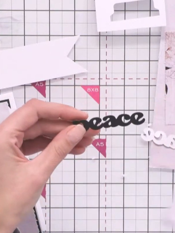 Step 9: Adhere the black die-cut sentiment to your card front, positioning it centrally or as desired on the white pan