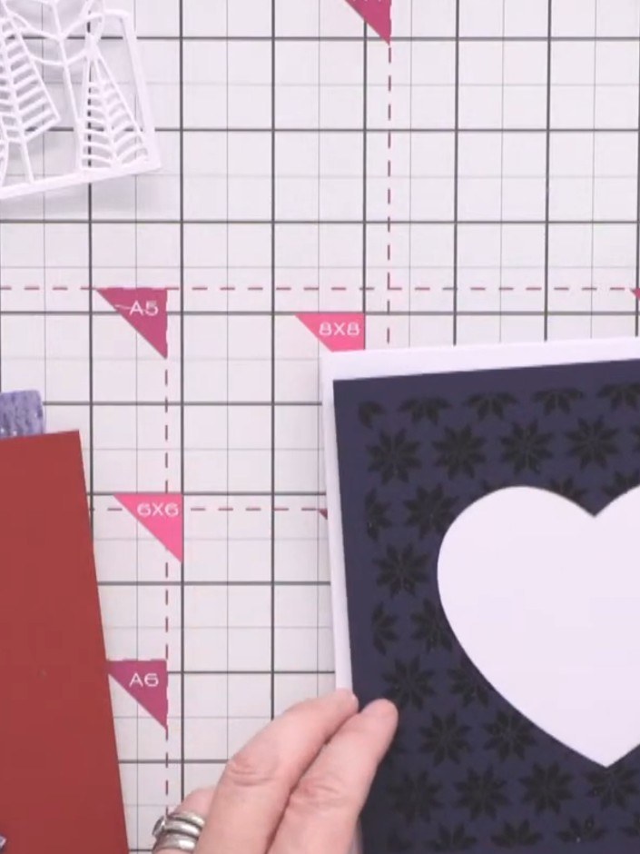Step 4: Die-cut a large heart aperture from the dark blue embossed panel using a heart die. The heart shape will be cu