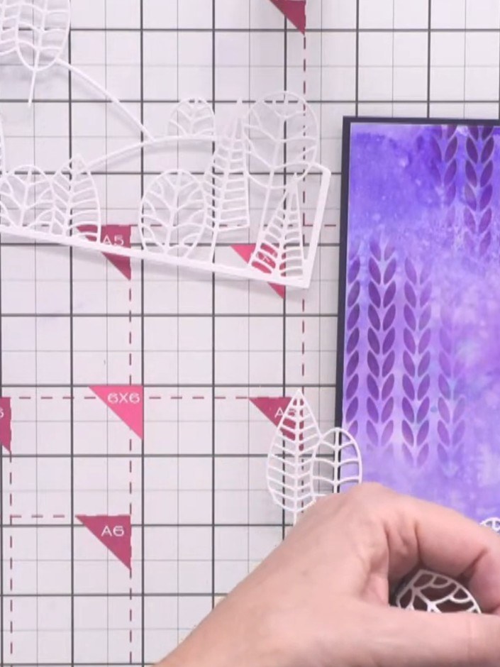 Step 11: Cut away sections from the second white die-cut to create a middle hill layer. Trim the bottom portion and kee