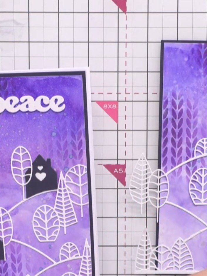 Step 12: Trim the third die-cut piece to show only the top trees, cutting away the lower portion. This creates a layere