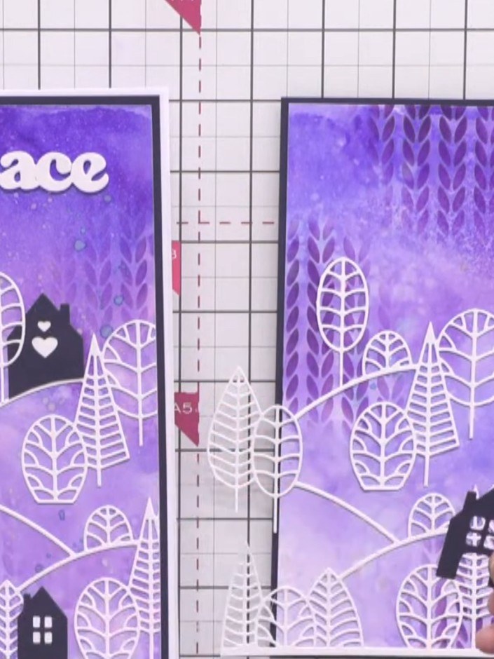 Step 13: Glue each layer of the country view scene onto the inky background card, stacking the die-cut houses and trees
