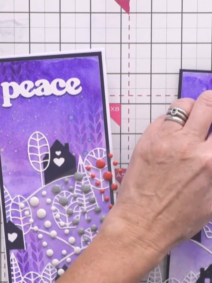 Step 15: Add an enamel dot on top of the festive word die-cut to complete the card. Position the dot centrally for a po