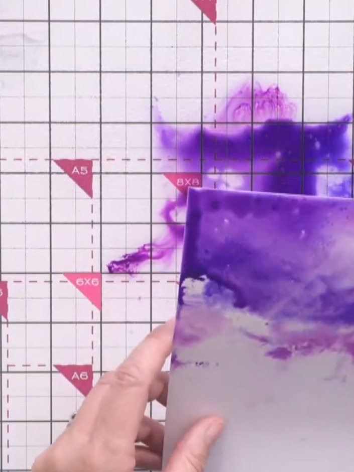 Step 3: Dip the wet cardstock into the indigo ink pad, allowing the purple colour to spread and blend across the surfa
