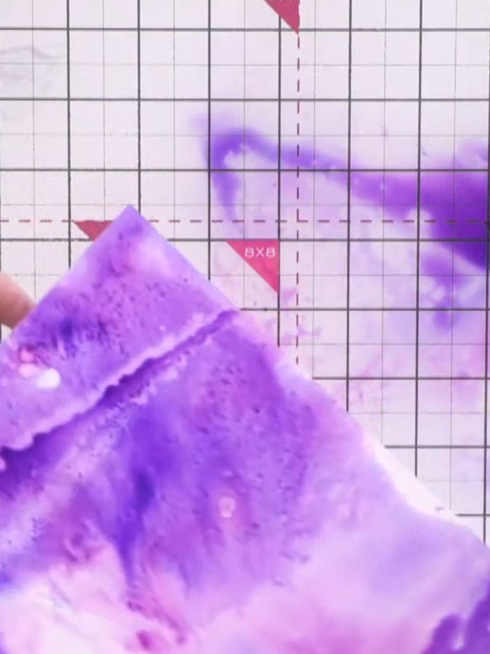 Step 5: Spritz confetti shimmer ink onto the wet purple background to add sparkle and further colour variation. The sh