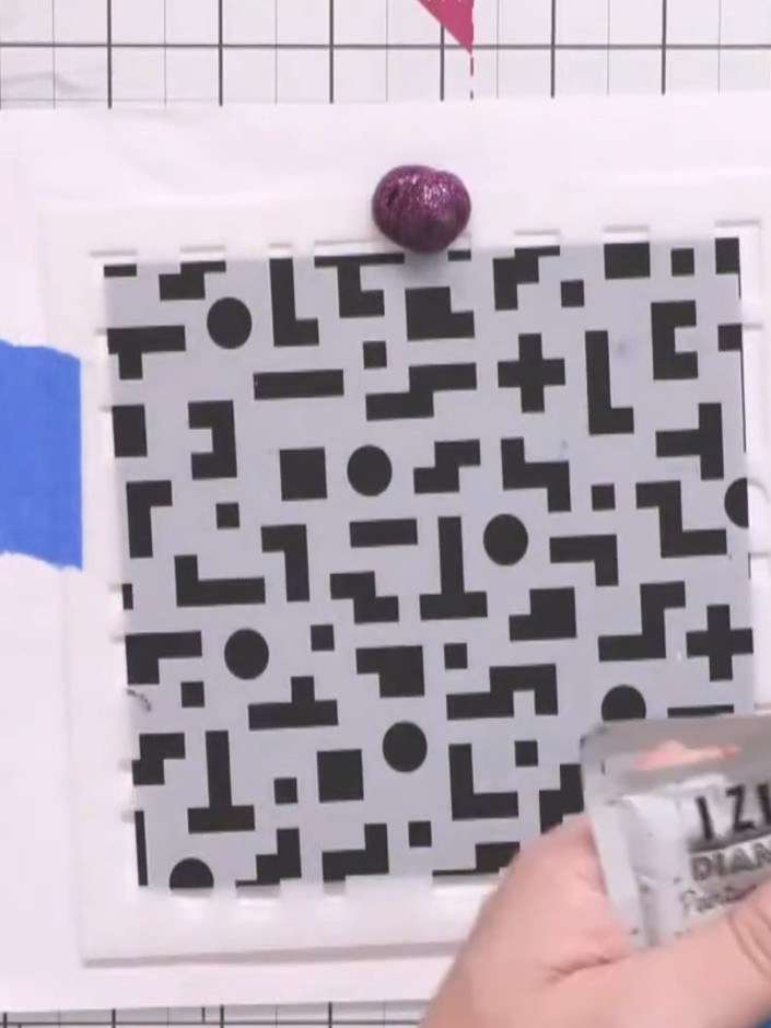Step 3: Apply a blob of purple texture paste at the top of the stencil using the applicator nozzle.