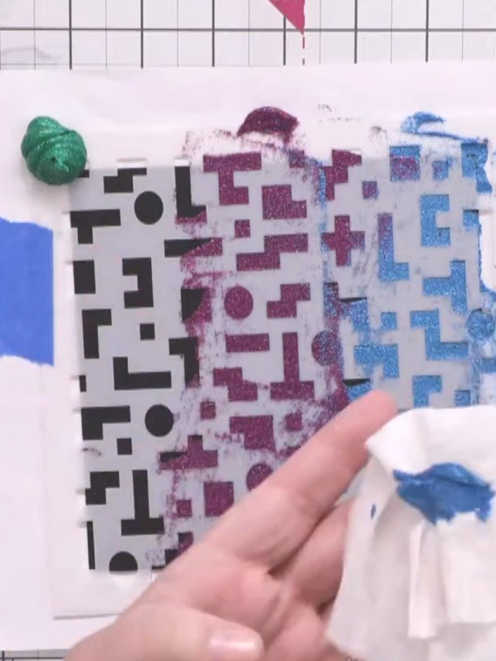 Step 7: Remove the excess paste from the top of the stencil using a baby wipe or cloth. Lightly blend the colours toge