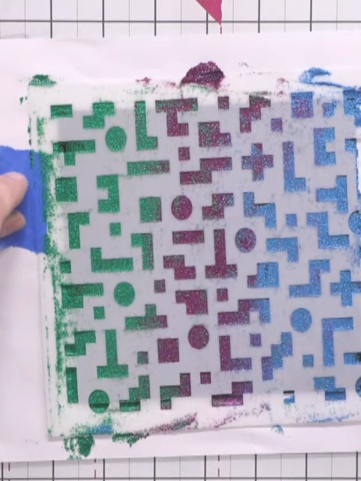 Step 8: Carefully lift off the stencil to reveal the textured pixel pattern with crisp edges and shimmering gradient e