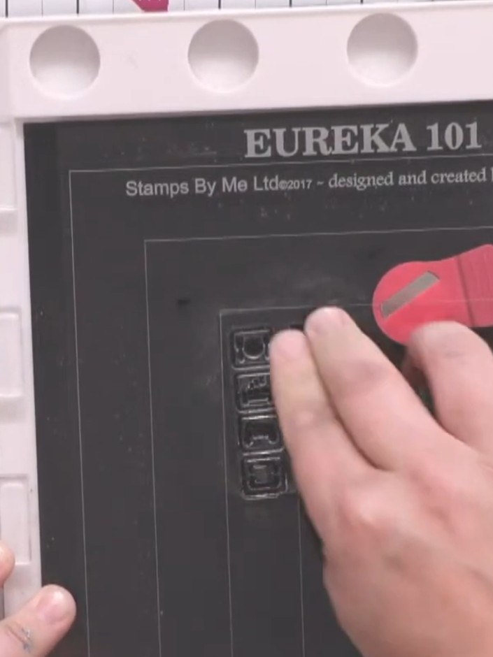 Step 3: Press the Game Over stamp firmly onto the black card square to create a clear, crisp impression in the centre.