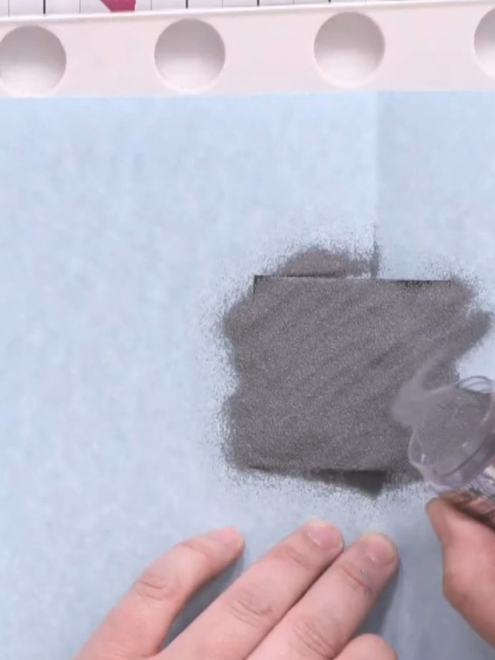 Step 4: Place a piece of scrap paper under the stamped card to catch excess embossing powder. This will make it easier