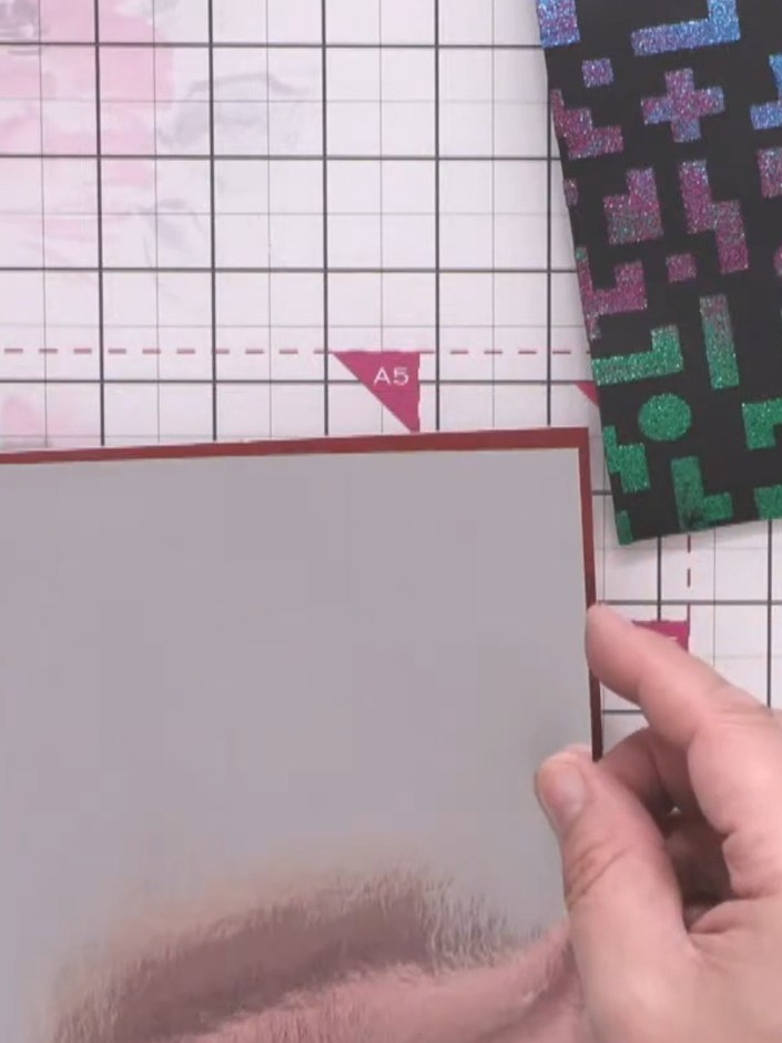 Step 2: Apply tape runner adhesive to the back of the silver mirror card layer and attach it centrally to the burgundy