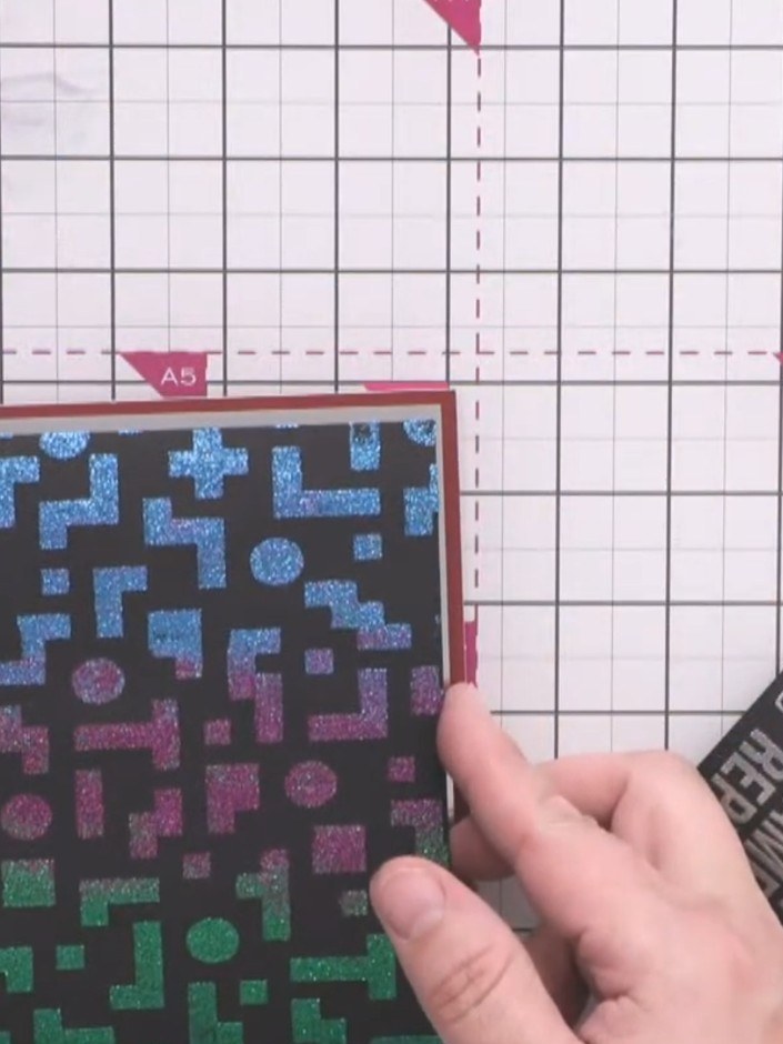 Step 3: Apply tape runner adhesive to the back of the black pixel pattern card. Position it onto the silver mirror car
