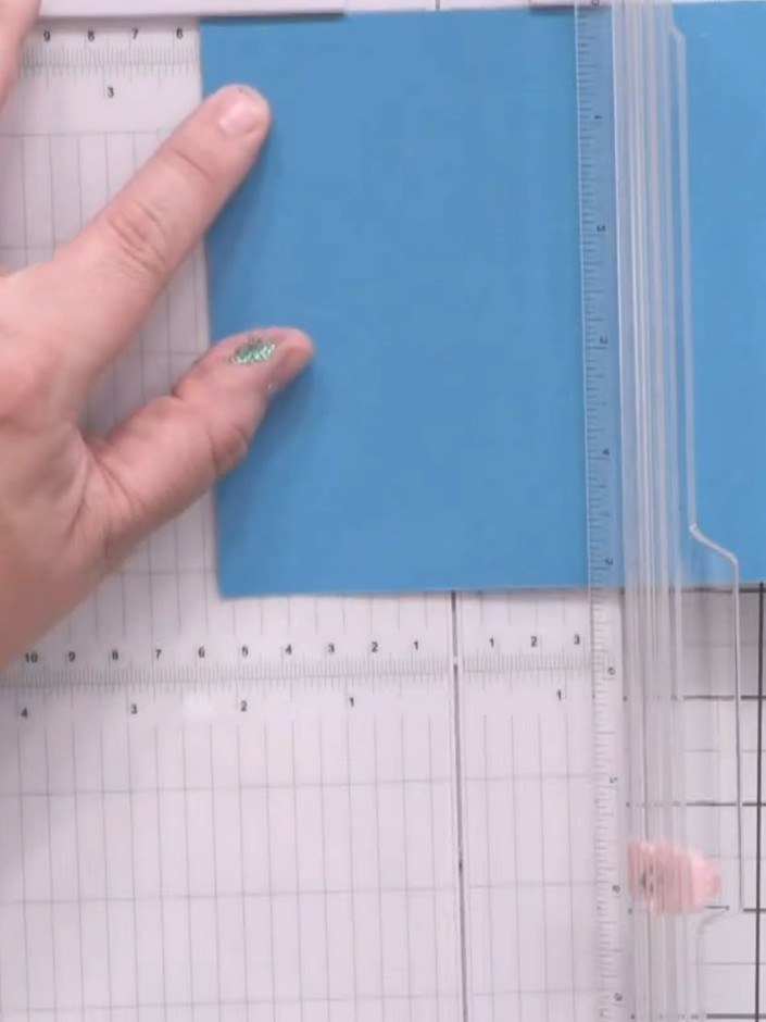 Step 1: Cut a piece of blue card measuring 5¼ inches by 8½ inches for the outer card base.