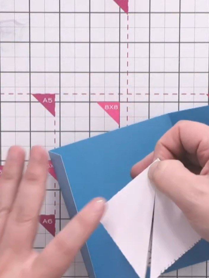 Step 12: Apply tape runner adhesive to the centre edges of the white explosion insert piece.