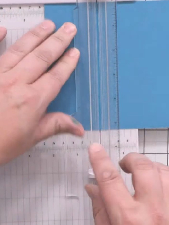 Step 2: Score the blue card at 2⅛ inches down one side using a scoring board.