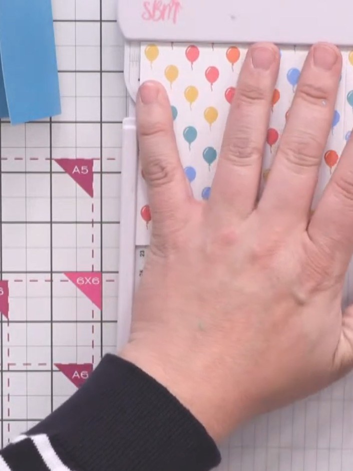 Step 7: Score the patterned paper strip at 2-inch intervals using your scoring board. Hold the paper firmly in place w