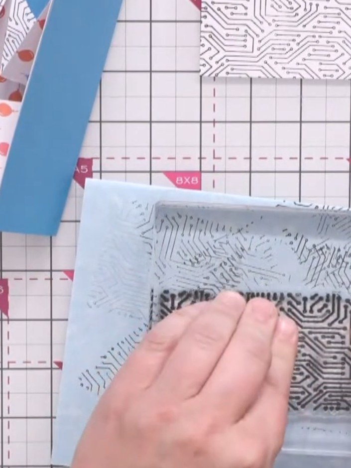 Step 3: Apply tape runner adhesive to the back of each stamped panel. Turn each panel over and run the tape runner acr