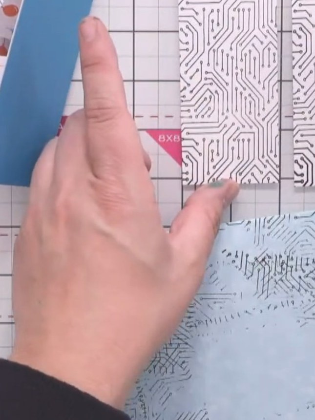 Step 4: Position the stamped panels on the front flaps of the card base, leaving a small border of blue cardstock visi