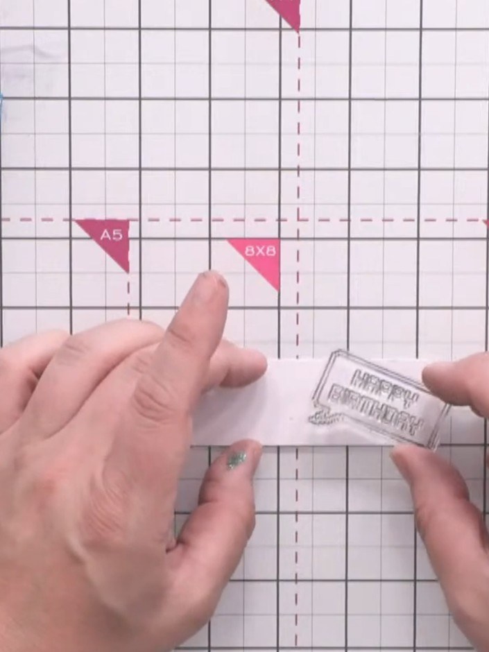 Step 8: Stamp a 'Happy Birthday' sentiment bubble onto the belly band using black ink. Position the stamp centrally on
