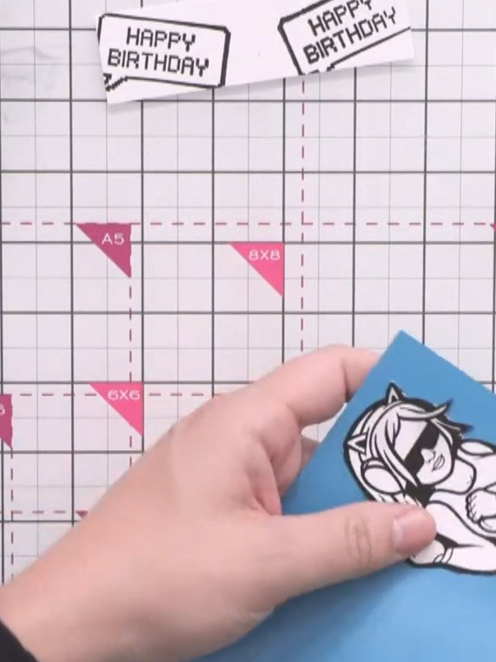 Step 4: Apply tape runner adhesive to the back of the black-stamped character. Mount the character onto the blue colou