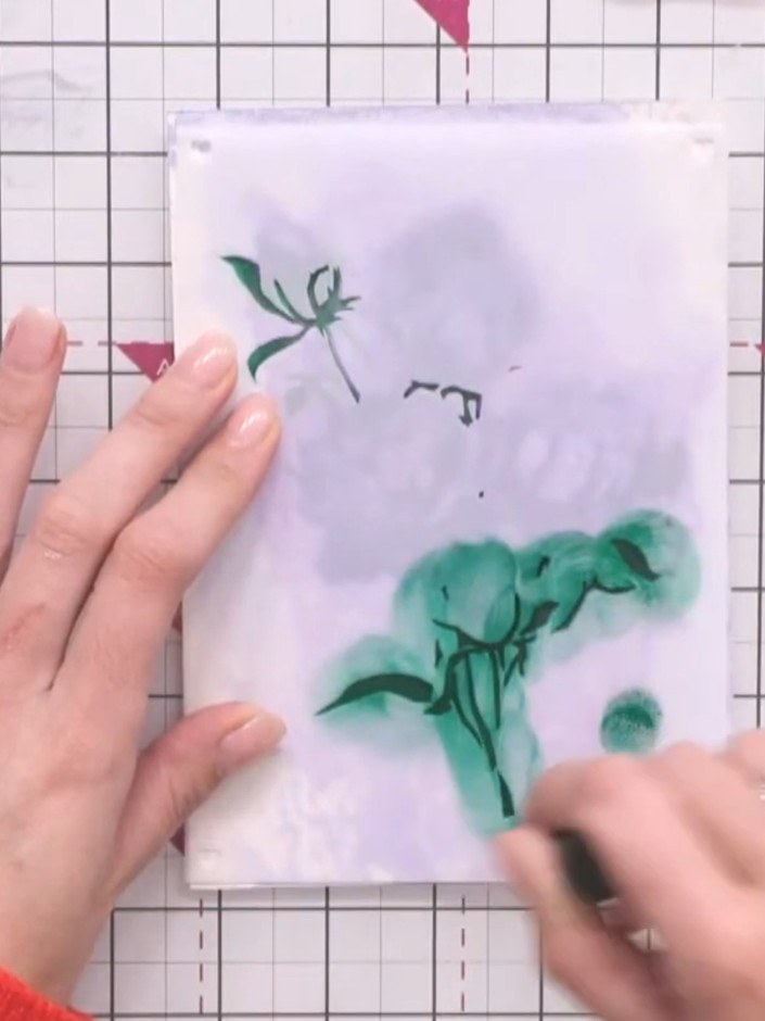 Step 11: Position the fourth stencil layer and press firmly with the same green ink to complete the magnolia flower des