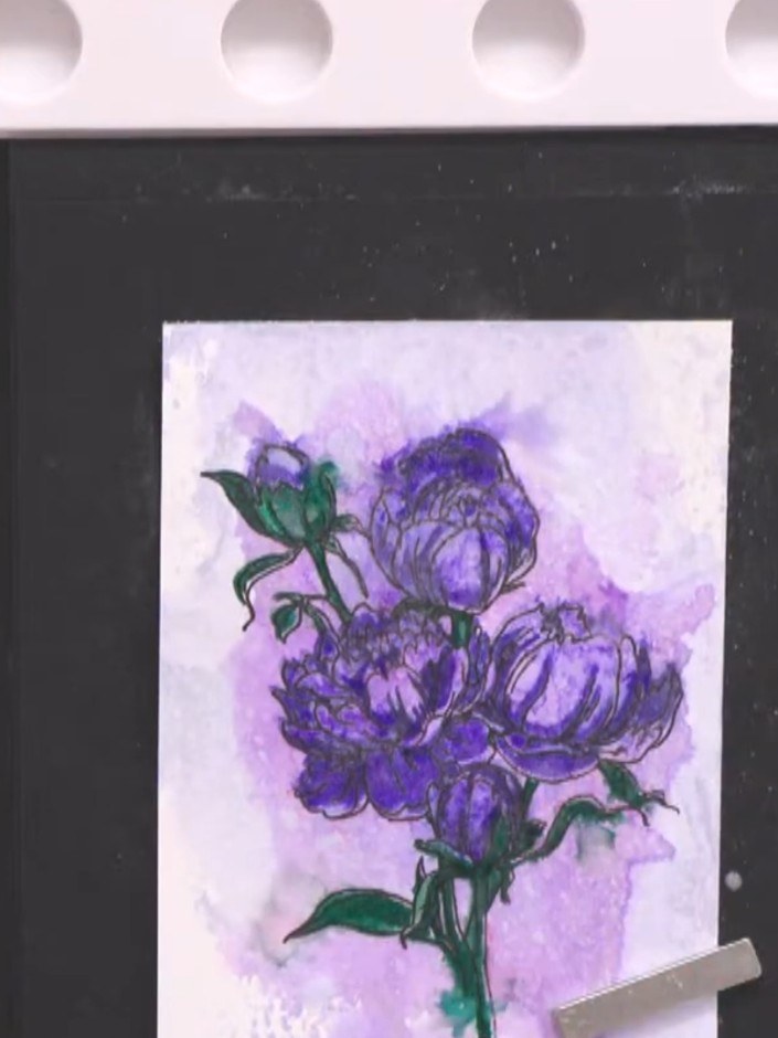 Step 14: Lightly spritz the artwork with water using a spray bottle to allow the pink ink to bleed slightly into the fl