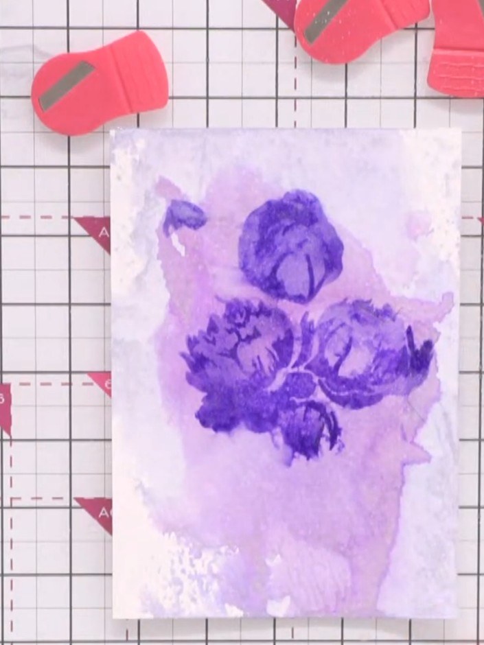 Step 9: Spritz the stamped card lightly with water spray to create a watercolour bleeding effect and soften the stenci
