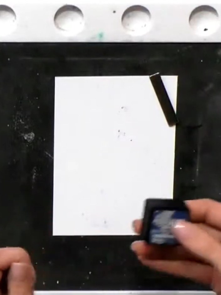 Step 2: Spray the inked stamp with water to create a watercolour bleed effect on the pink gown image.