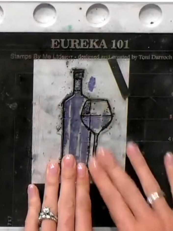 Step 4: Using black ink, stamp the solid colour portion of the wine bottle stamp over the watercoloured image. This wi