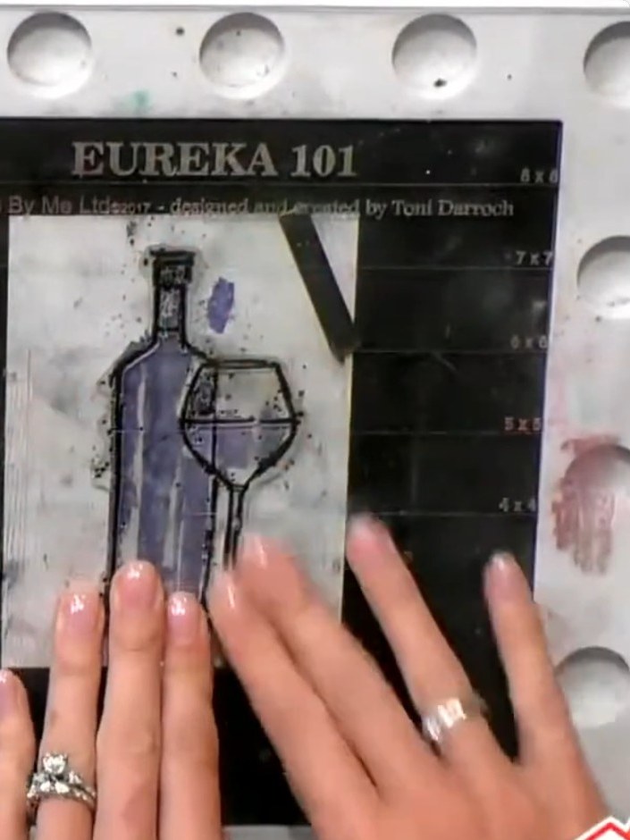 Step 6: Mat the stamped wine bottle design onto black cardstock. Position the white stamped panel centrally on the bla
