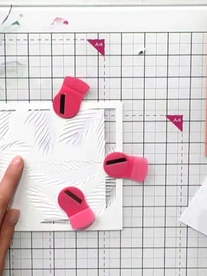 Step 2: Apply the feather stencil to your white card using the chip sapphire ink pad. Hold the stencil in place with o
